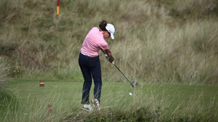 Female golfer taking a swing