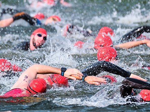 close up of triathletes on swimming stage